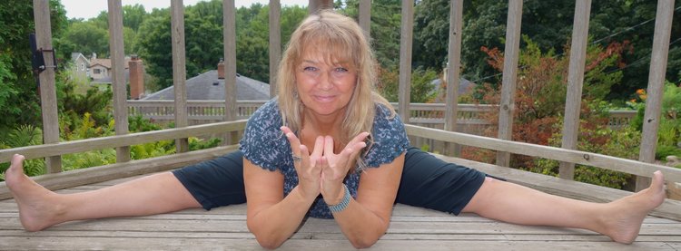 Tara Cindy Sherman demonstrates dragonfly pose and lotus mudra.