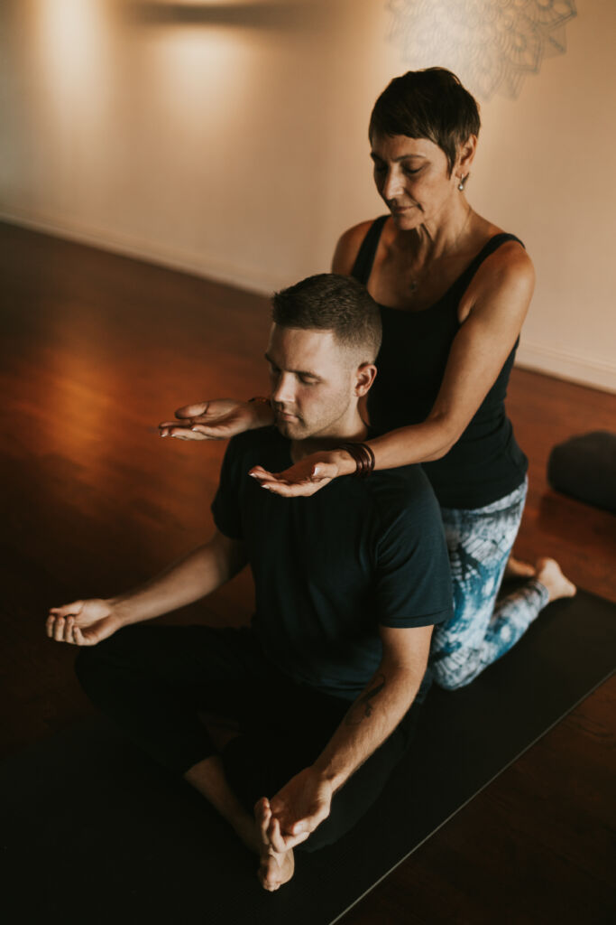 Cody Cooper and Holly Schramm practicing Reiki